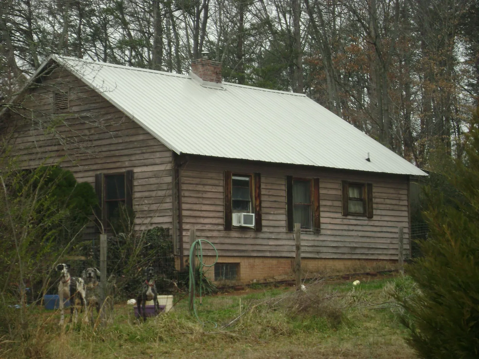 White metal roof on an old wood sided farmhouse, from a Metal Roof Installation job in Leipsic